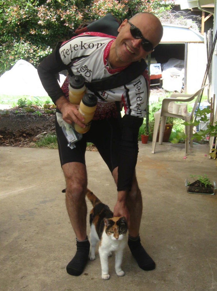 Niles Burton at home in Eugene, Oregon, with a calico cat